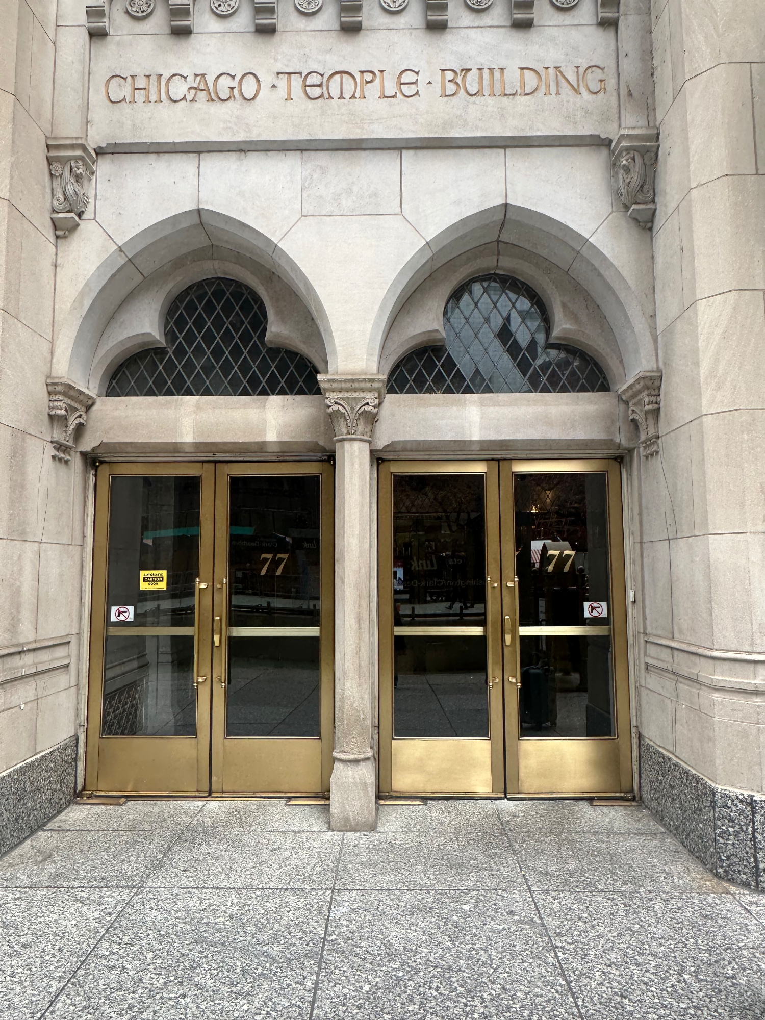 A set of architectural arched doors with the angel numbers 77 in the most gorgeous gold font.